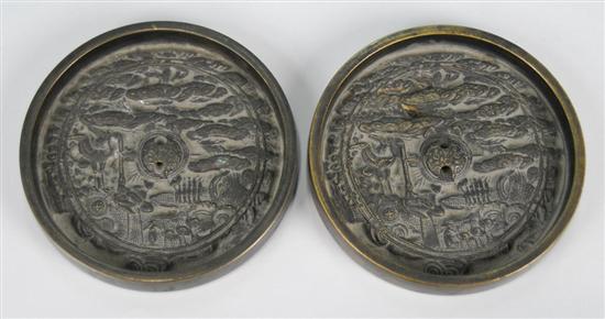 Appraisal: TWO CHINESE POLISHED BRONZE HAND MIRRORS decorated in relief with