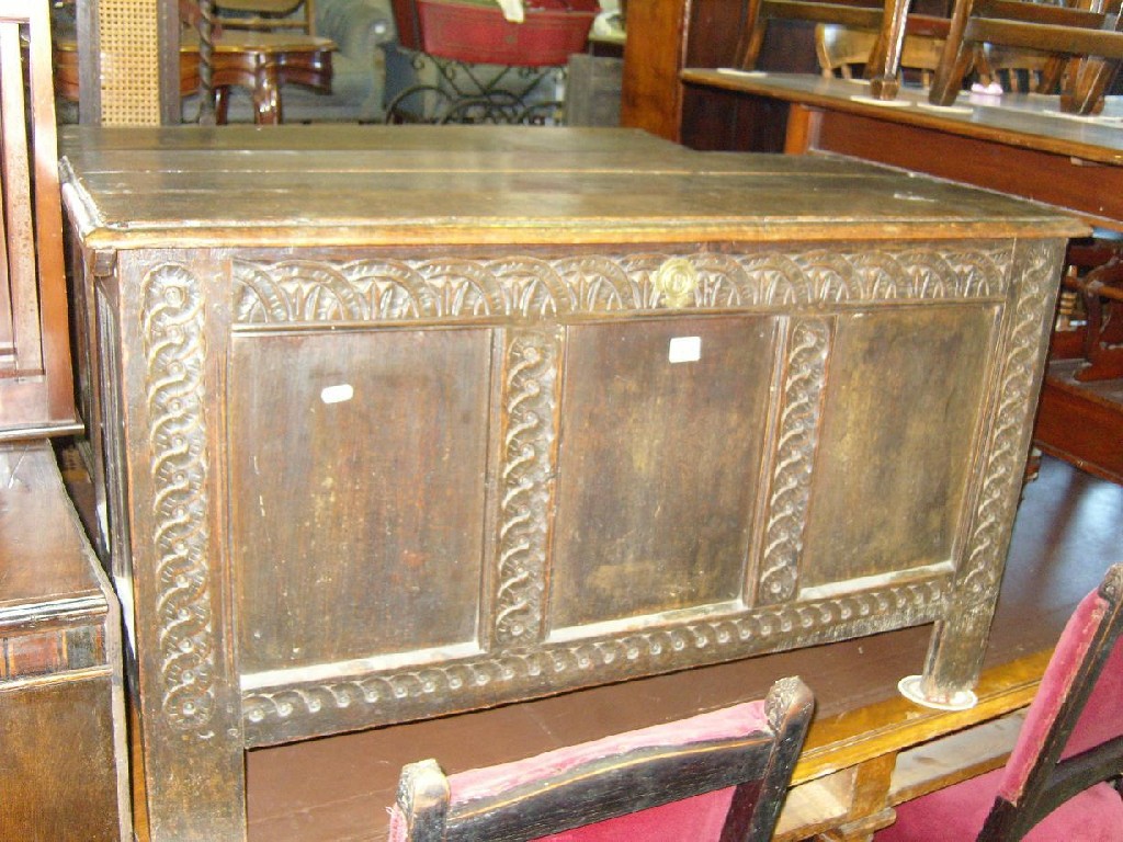 Appraisal: A Georgian oak coffer fitted with rising lid and carved