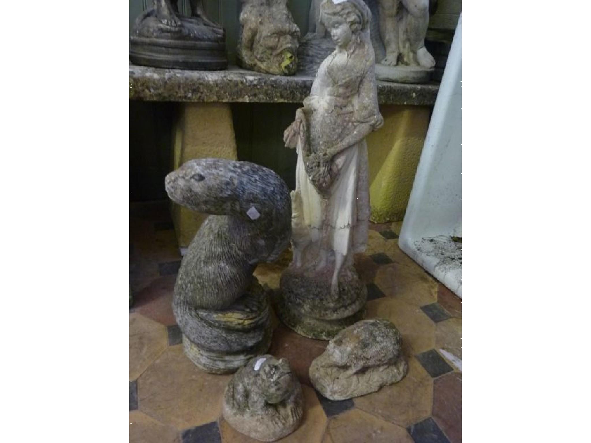 Appraisal: A small weathered composition stone garden figure of a maiden