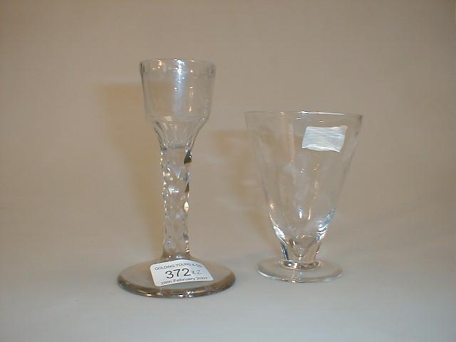 Appraisal: A Victorian wine glass with wide foot and faceted stem