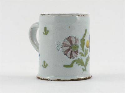 Appraisal: A Delftware mug painted with a polychrome spray of flowers