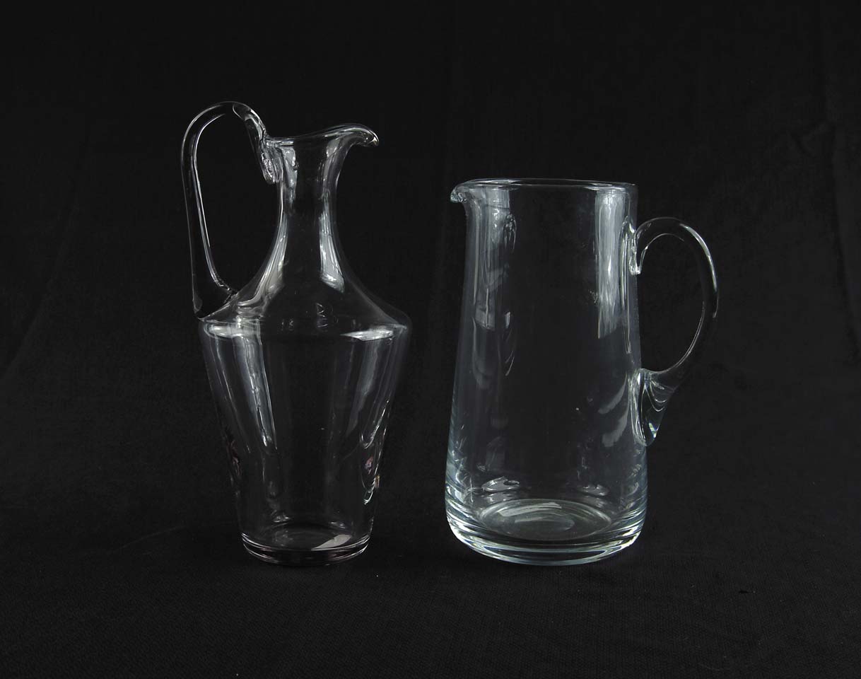 Appraisal: TWO BLOWN GLASS PITCHERS Clear glass pitcher has slightly tapering