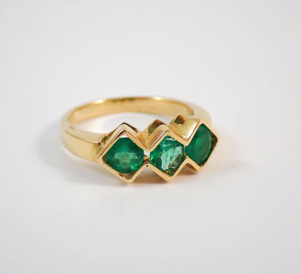 Appraisal: EMERALD AND EIGHTEEN KARAT GOLD RING set with three oval-cut