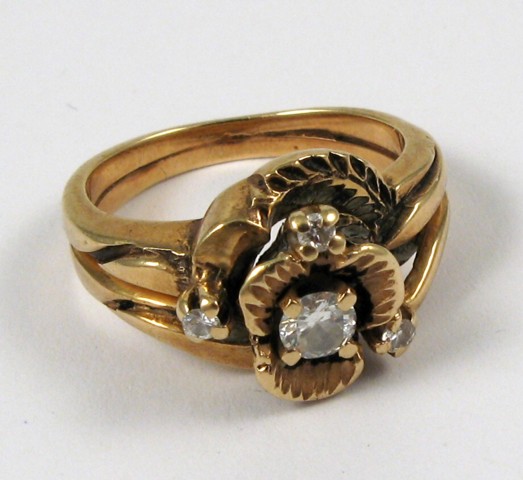 Appraisal: DIAMOND AND FOURTEEN KARAT GOLD RING centering a round-cut diamond