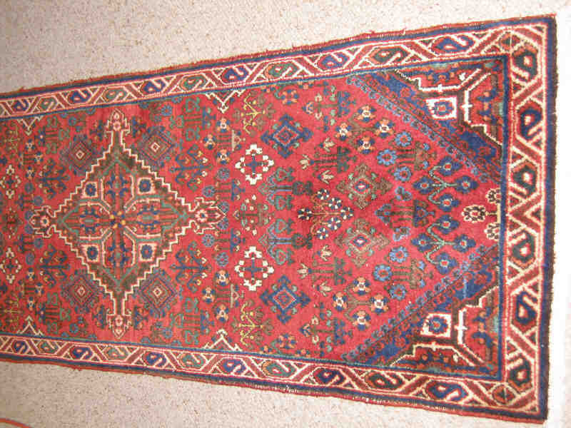 Appraisal: MEIMEH THROW RUG The red field of diamond medallions centers