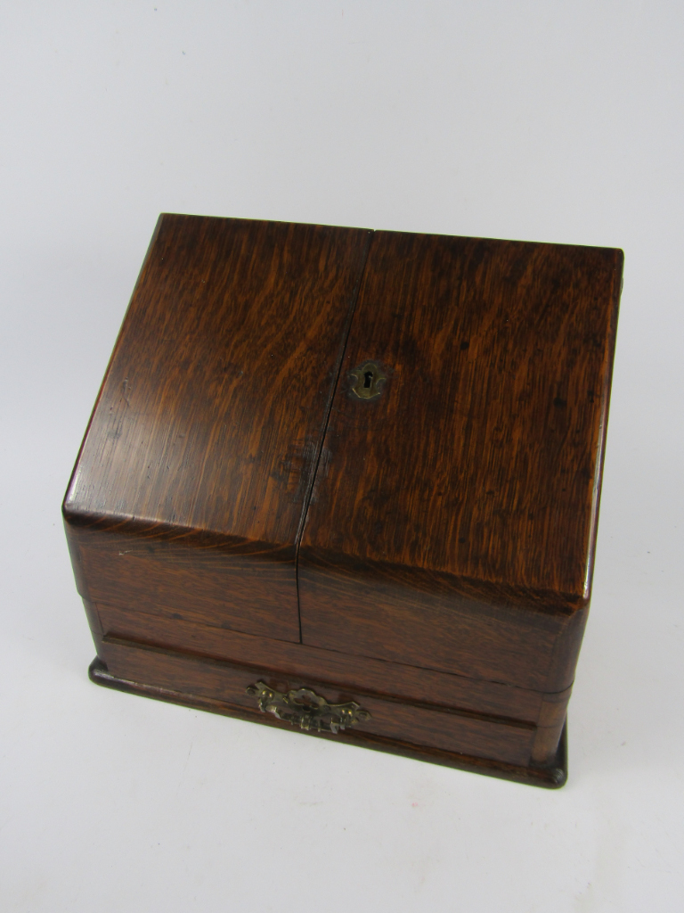 Appraisal: A Victorian oak stationery rack the two doors opening to