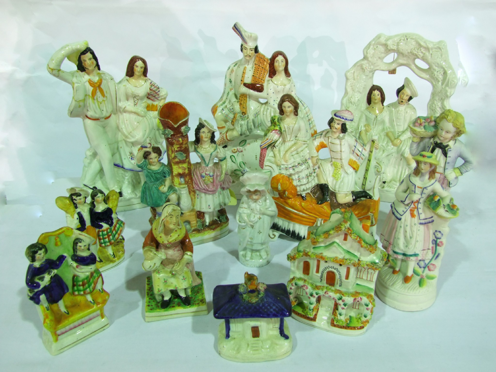 Appraisal: A collection of th century Staffordshire figure groups including male