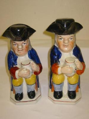 Appraisal: TWO STAFFORDSHIRE POTTERY TOBY JUGS modelled as seated topers each