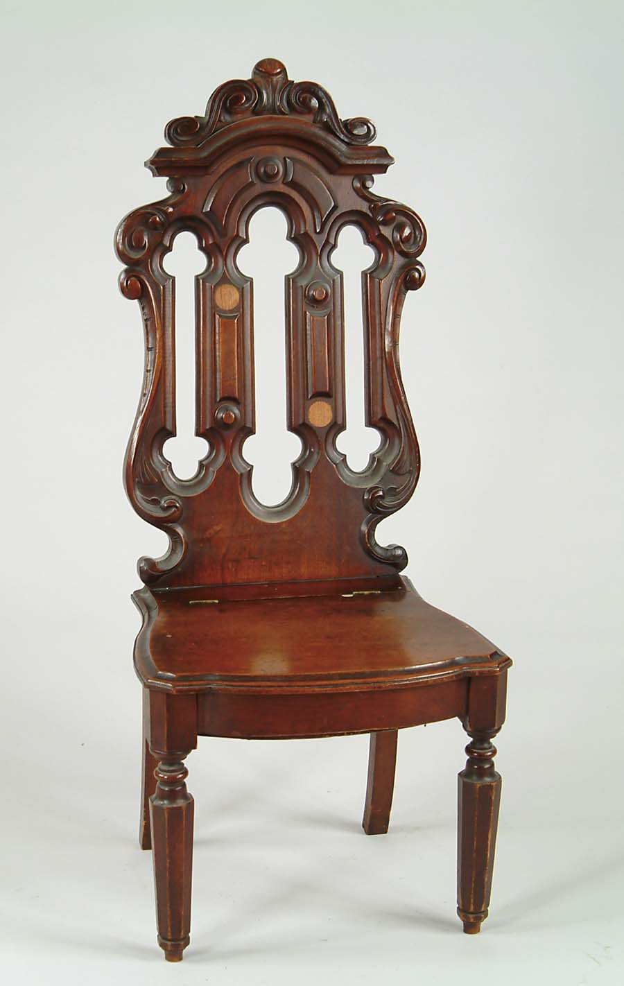 Appraisal: VICTORIAN GOTHIC REVIVAL WALNUT CARVED CHAIR Solid seat is hinged