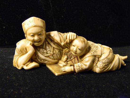 Appraisal: Japanese th century ivory figure of a mother reclining at