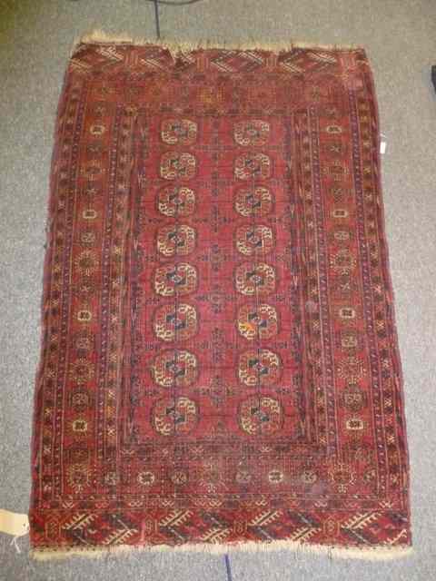 Appraisal: A BOKHARA RED GROUND RUG with central elephant foot medallion