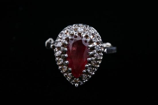 Appraisal: K WHITE GOLD DIAMOND AND RUBY RING Pear shape ruby