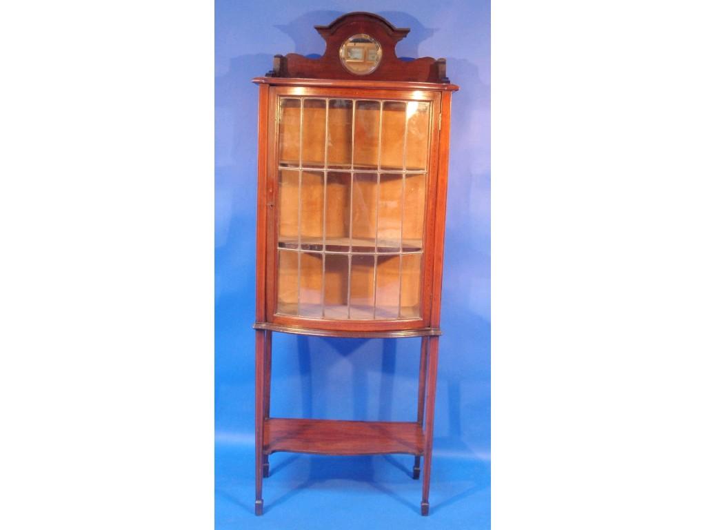 Appraisal: An Edwardian inlaid mahogany bow fronted display cabinet the shaped