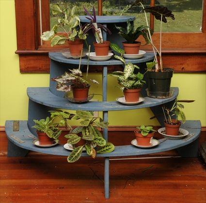 Appraisal: GREEN-PAINTED FOUR-TIER PLANT STAND Comprised of four graduated semi-circular shelves