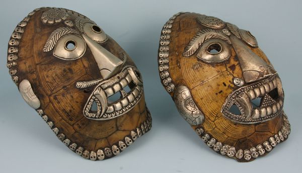 Appraisal: Pair of South American tortoiseshell masks with silver trim having