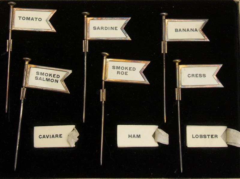 Appraisal: BOXED SET OF SIX ENGLISH SILVER-PLATED MENU PENNANTS Retailed by