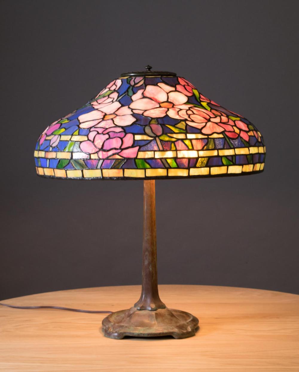 Appraisal: TIFFANY STYLE THREE-LIGHT TABLE LAMP with floral stained and leaded