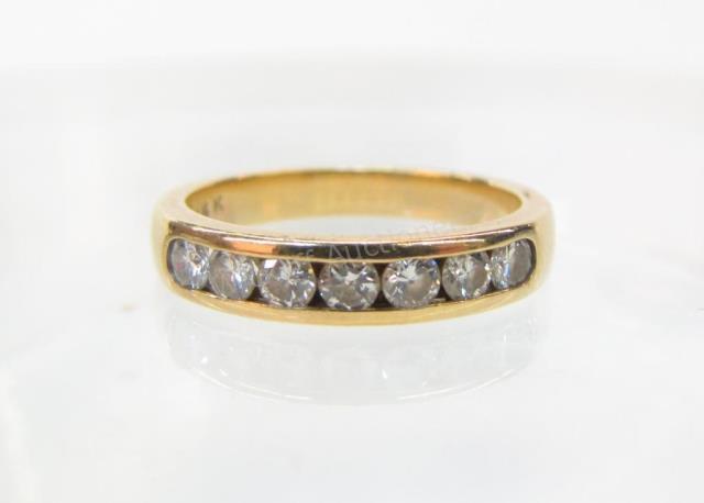 Appraisal: A lady's K yellow gold diamond wedding band with approximately