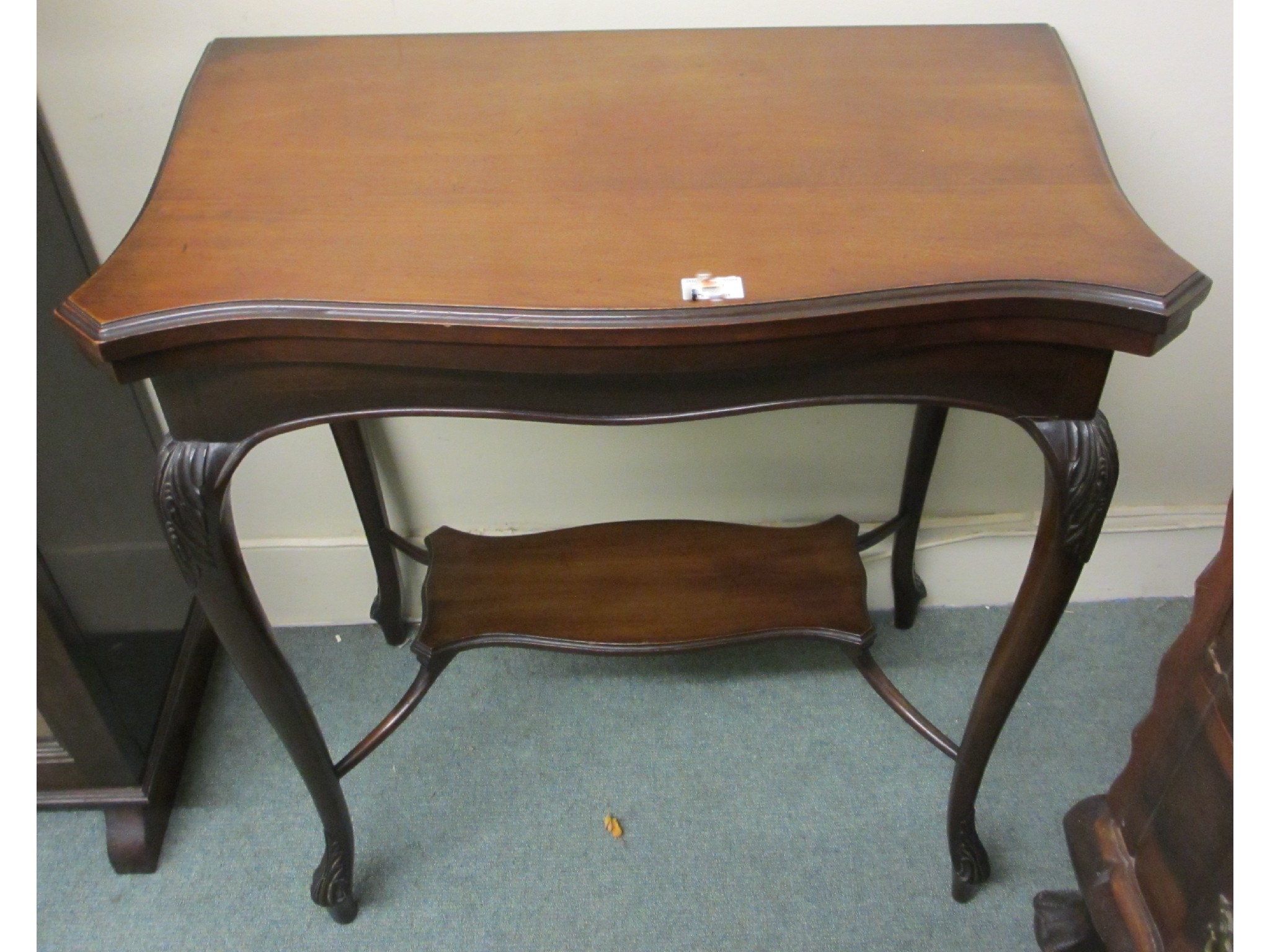 Appraisal: Edwardian mahogany serpentine card table