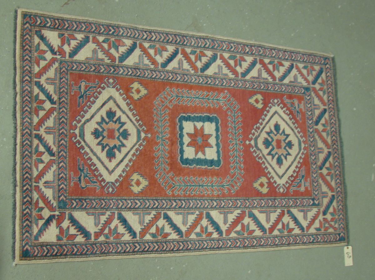 Appraisal: ORIENTAL RUG KAZAK DESIGN ' x ' Three geometric medallions