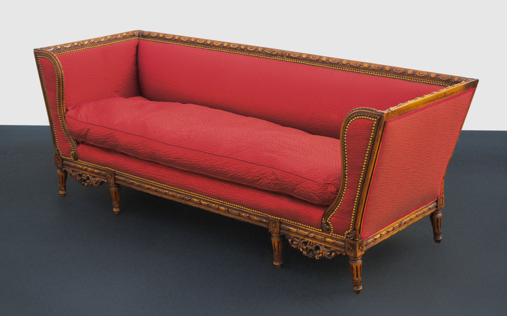 Appraisal: FRENCH STYLE CARVED SOFA Carved top rail shaped wing front