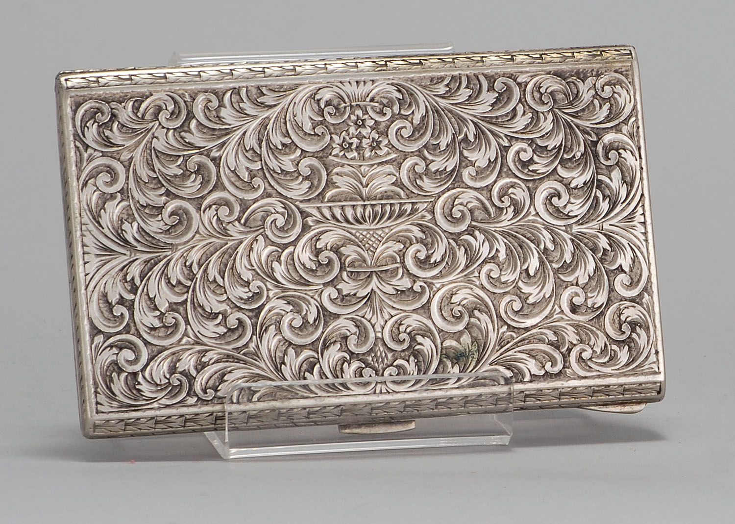 Appraisal: CONTINENTAL SILVER CIGARETTE CASE with elaborate foliate and floral engraving