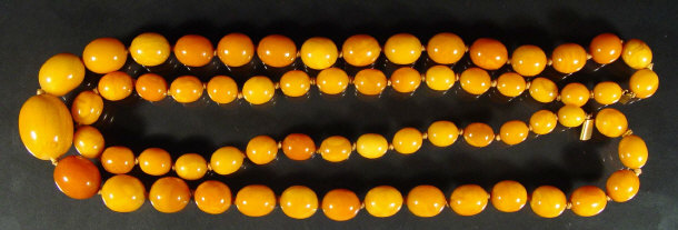 Appraisal: Double string of amber beads on an unmarked gold clasp