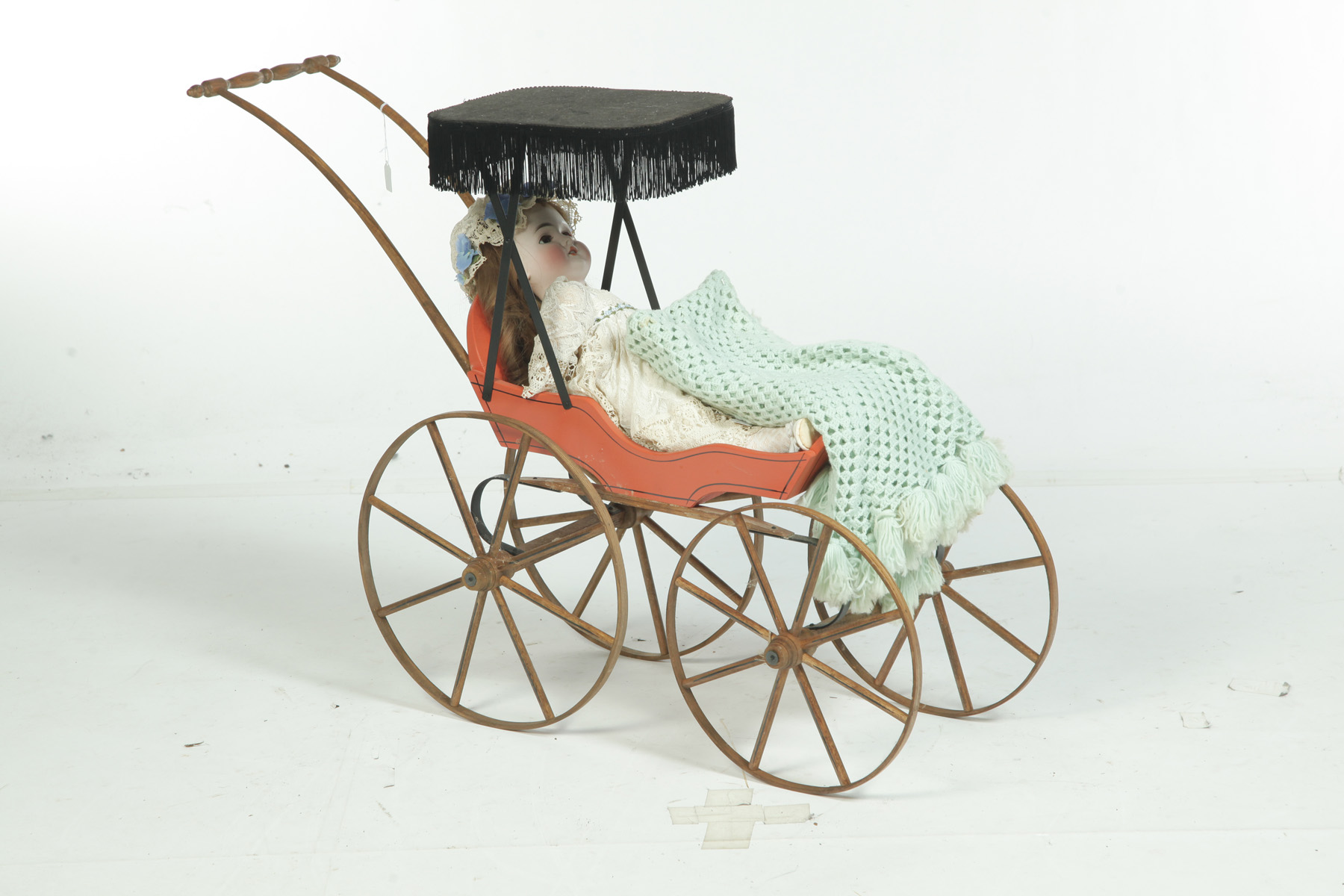 Appraisal: BISQUE HEAD DOLL IN CARRIAGE Germany th century Painted face