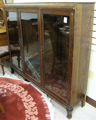 Appraisal: THREE-DOOR OAK CABINET BOOKCASE American c the interior divided into