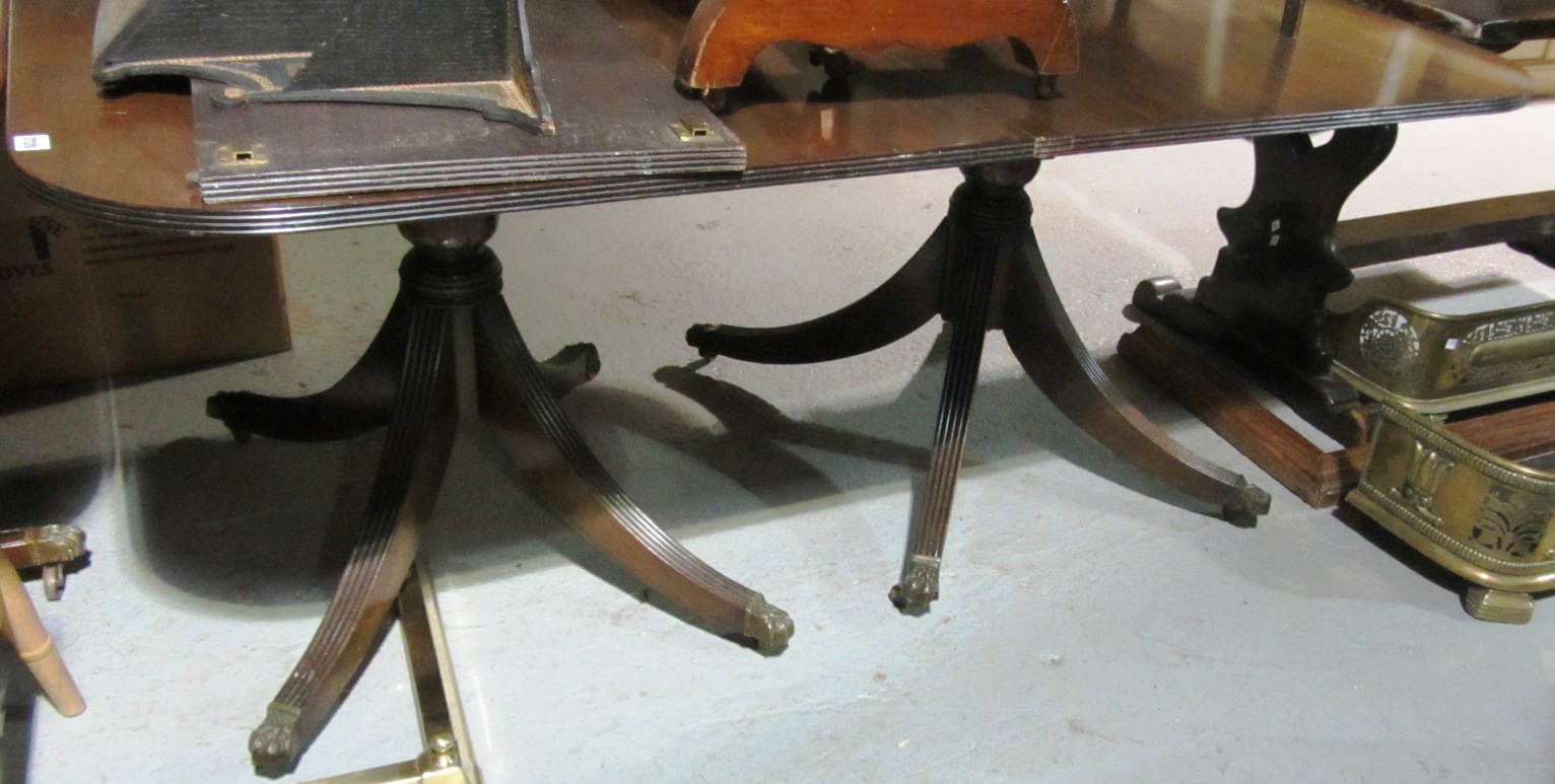 Appraisal: A th century mahogany twin pillar dining table