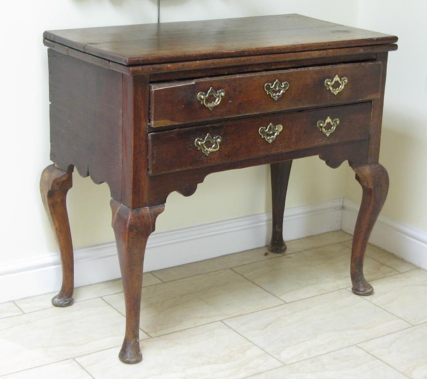 Appraisal: A Georgian walnut and oak Lowboy with associated fold-over top