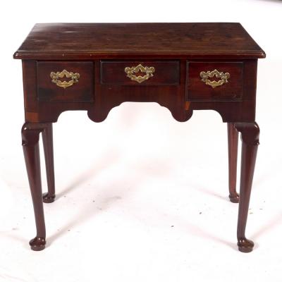 Appraisal: A George II mahogany three-drawer side table circa on cabriole