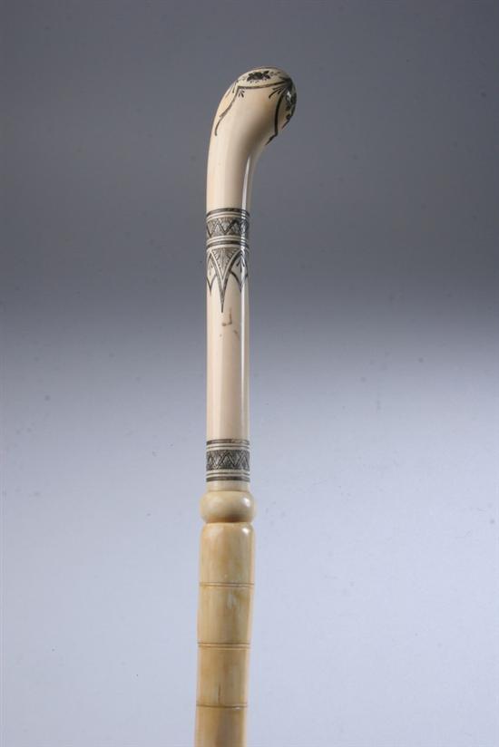 Appraisal: IVORY AND BONE CANE With in ivory curved handle elaborately