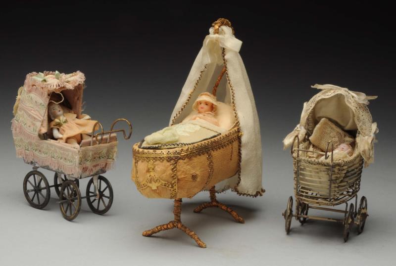 Appraisal: Lot Of Carriages and Cradle Early and lovely cardboard crepe