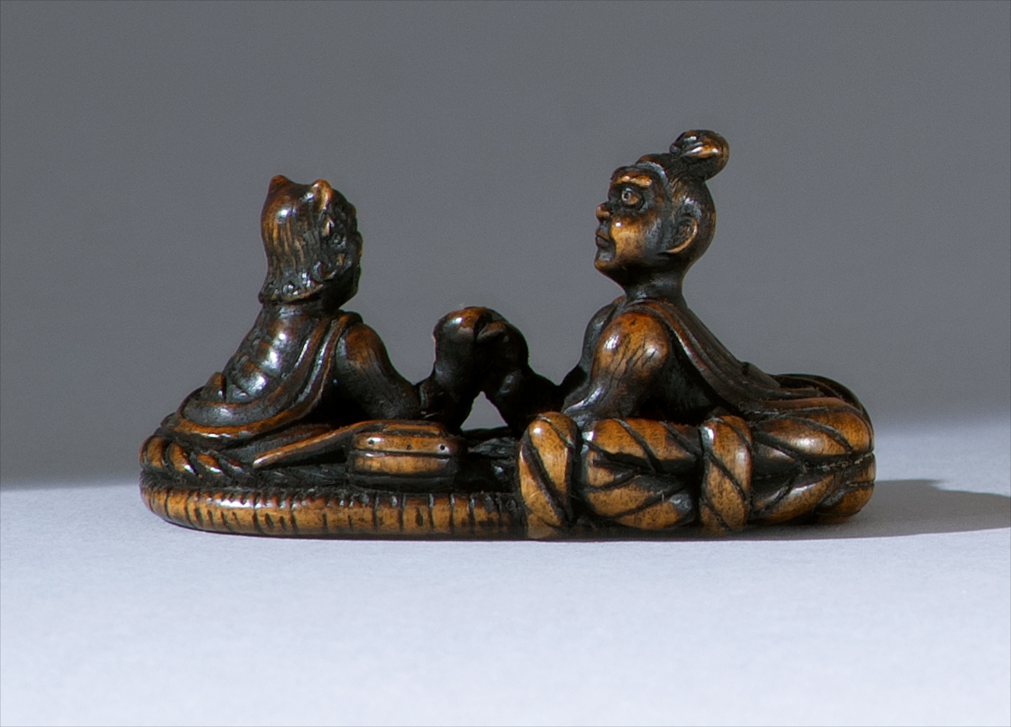 Appraisal: WOOD NETSUKE th CenturyDepicting a nio and an oni arm