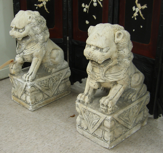 Appraisal: A PAIR OF CARVED LIMESTONE FOO LIONS Chinese th century