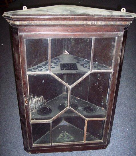 Appraisal: An oak hanging corner cupboard with astragal glazed door cm