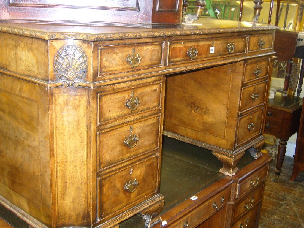 Appraisal: A good quality Georgian style walnut veneered kneehole pedestal desk