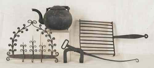 Appraisal: Decorative iron utensil rack together with an iron kettle with