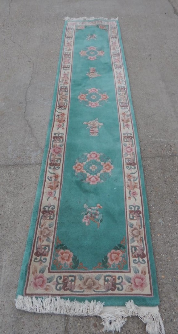 Appraisal: A Chinese wool cut runner with a design of flowers