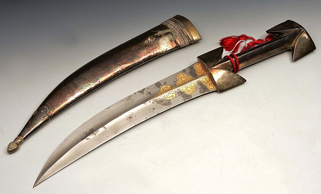 Appraisal: A MIDDLE EASTERN SHORT SWORD with a white metal handle