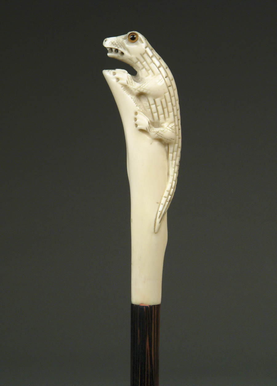 Appraisal: CARVED IVORY LIZARD CANE Long carved handle has a lizard