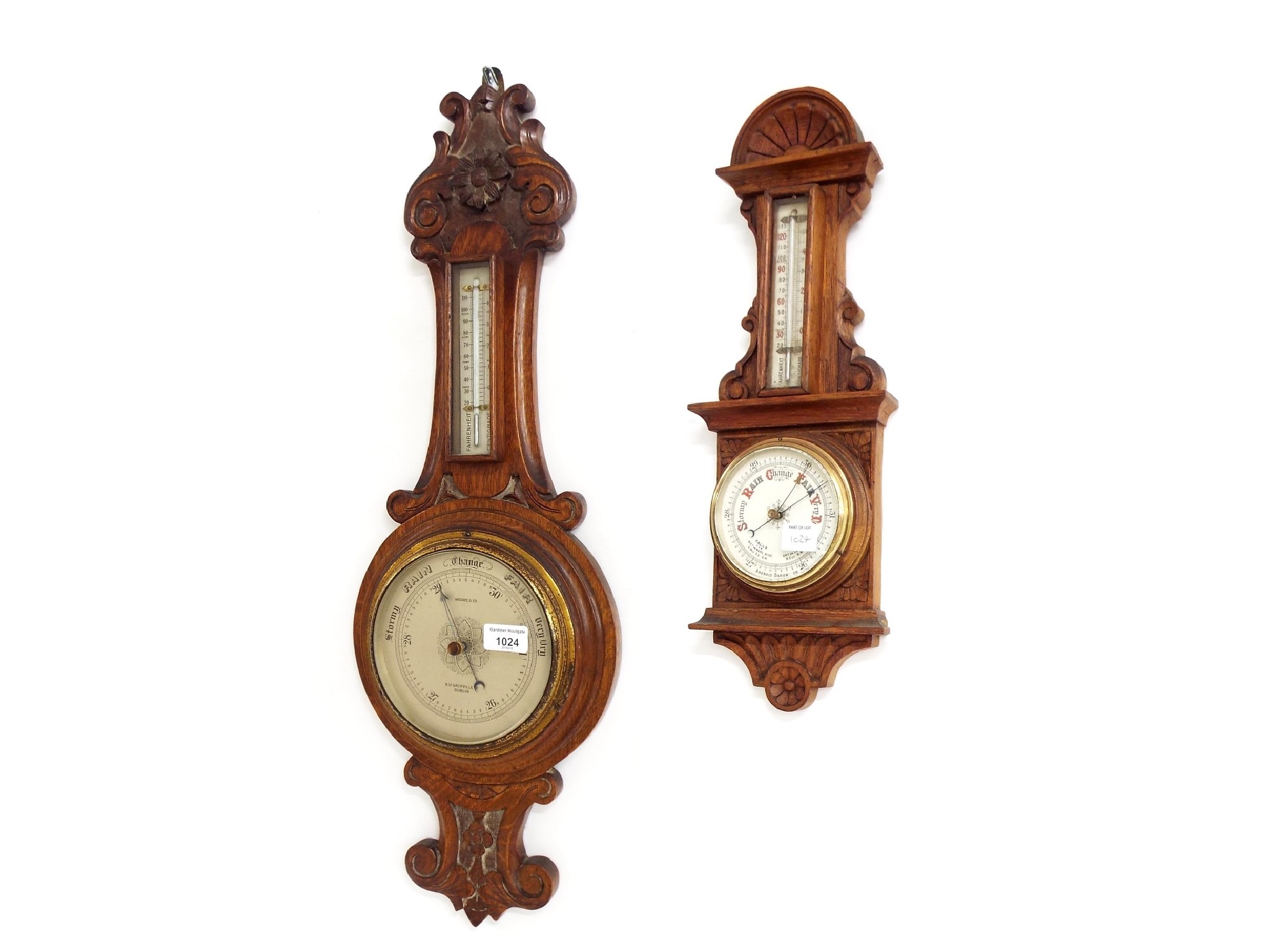 Appraisal: Two carved oak aneroid barometer thermometers the largest signed Moore