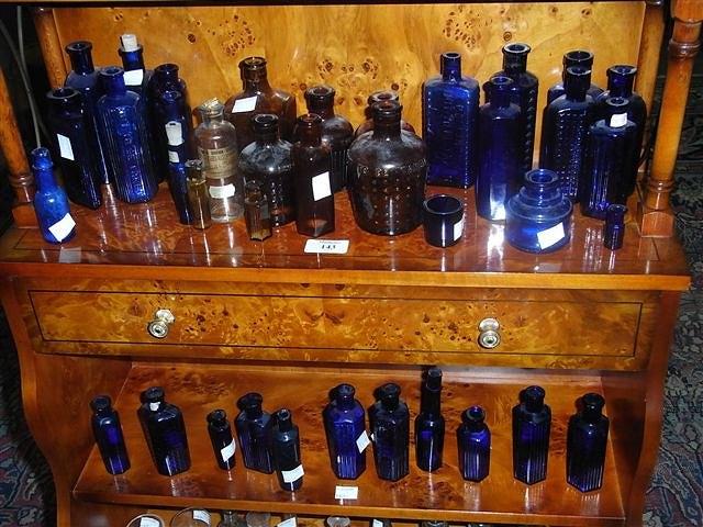 Appraisal: A COLLECTION OF SMALLER BLUE GLASS MEDICINE BOTTLES and a