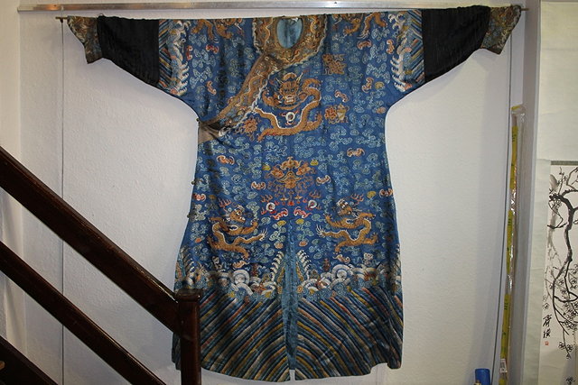 Appraisal: A CHINESE BLUE GROUND LONG ROBE with gold thread and