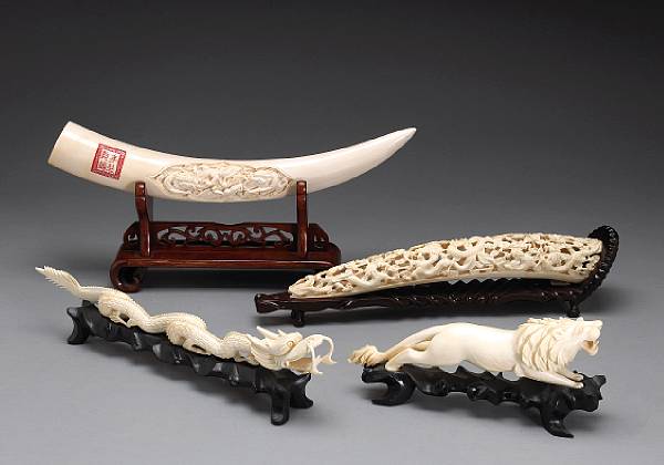 Appraisal: Four ivory tusk carvings th Century The first a model