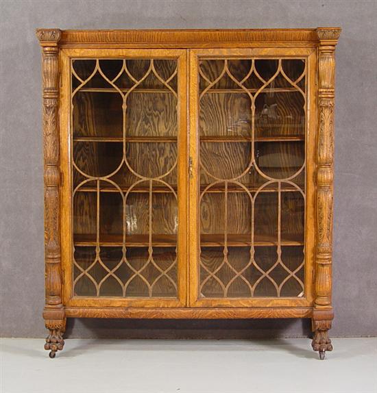 Appraisal: Fancy Golden Oak Bookcase Circa Two glazed doors with decorative