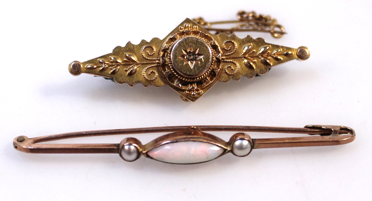 Appraisal: A bar brooch the ellipse body raised with scrolls and