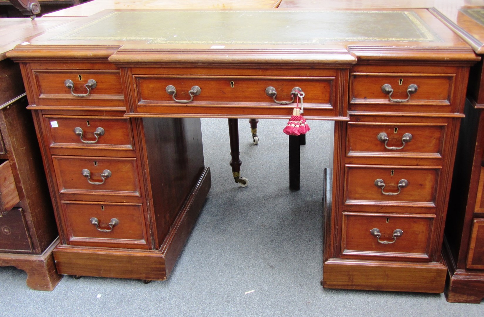 Appraisal: A th century walnut breakfront nine drawer pedestal desk cm