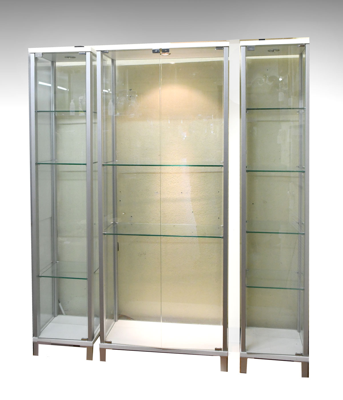 Appraisal: GLASS CURIO CABINETS silver white framed glass cabinets having single